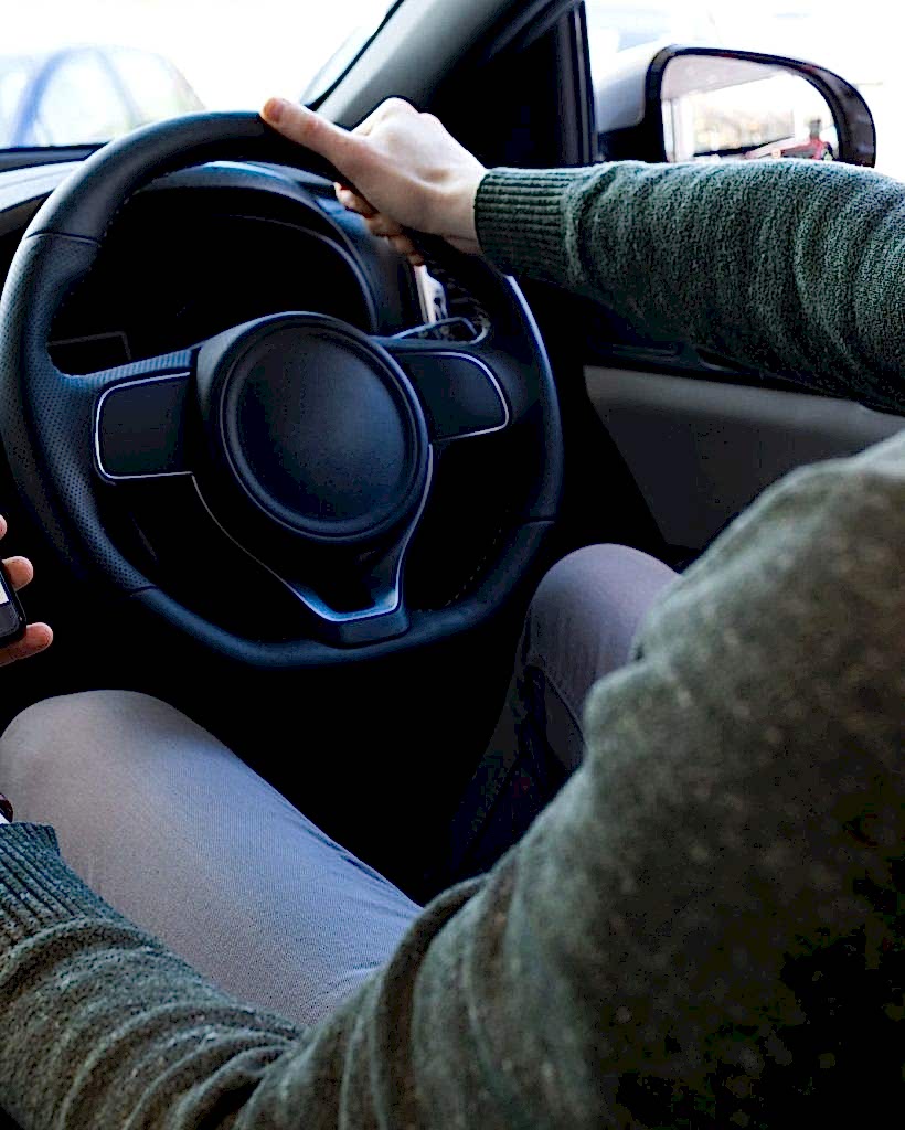 man-using-smartphone-while-driving-car.jpg